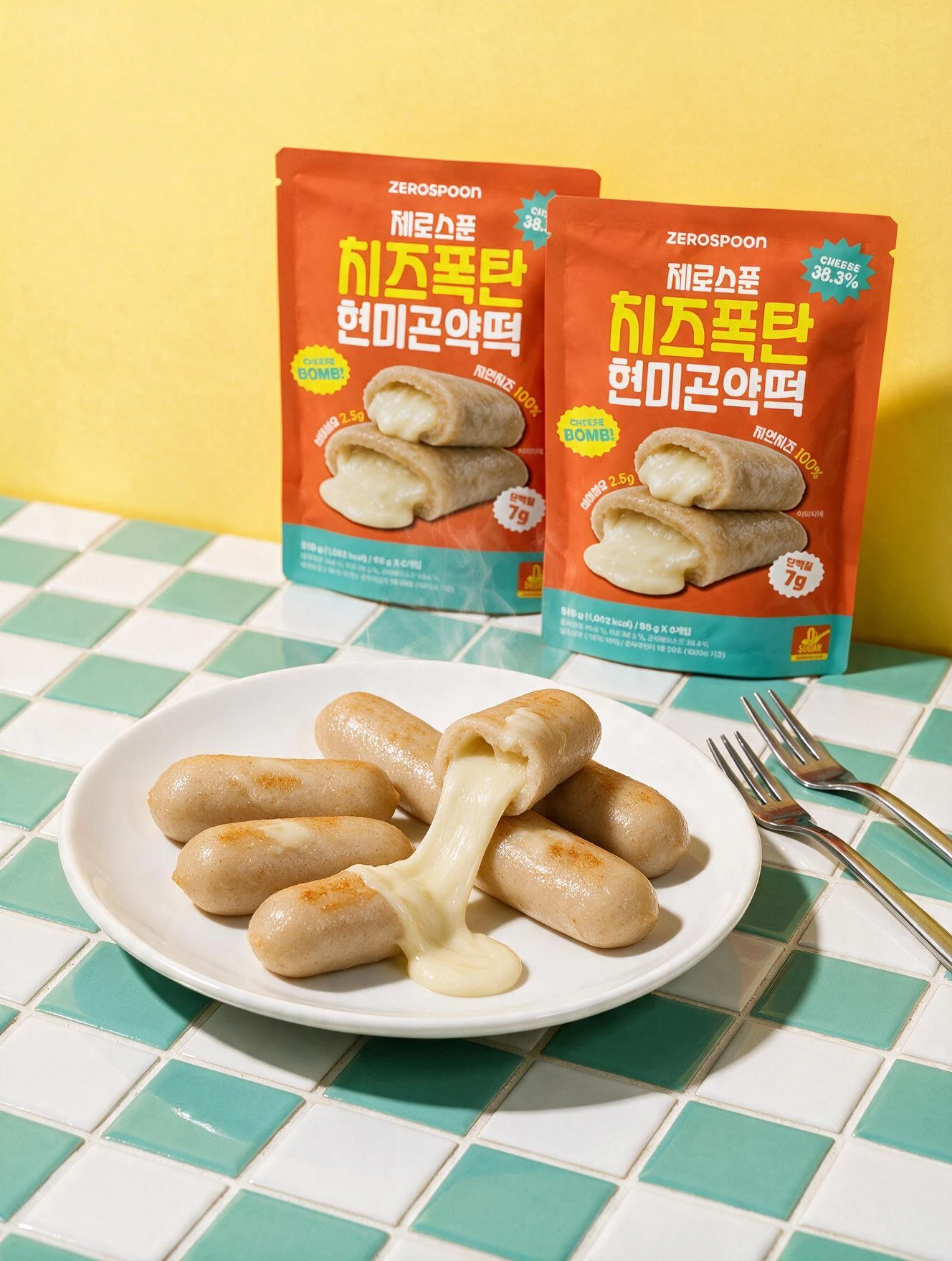Orange product pouches and cheese tteok on a mint tiled table